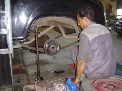 Sudesh at ACT India removes the half shaft to repair a gasket
